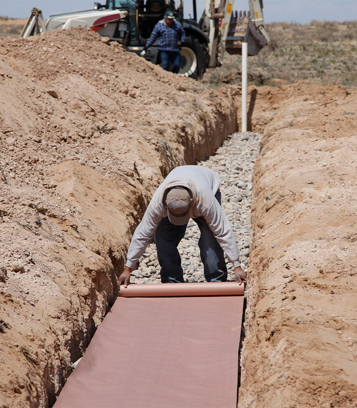 Laying paper in a drain field on new septic system